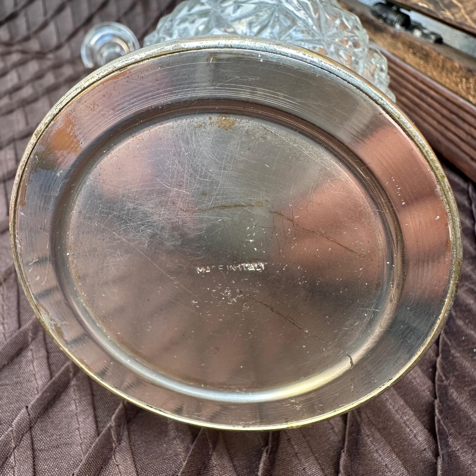 Close-up of a metallic object with 'M.P.E. INDUSTRIES' engraving on a textured surface.