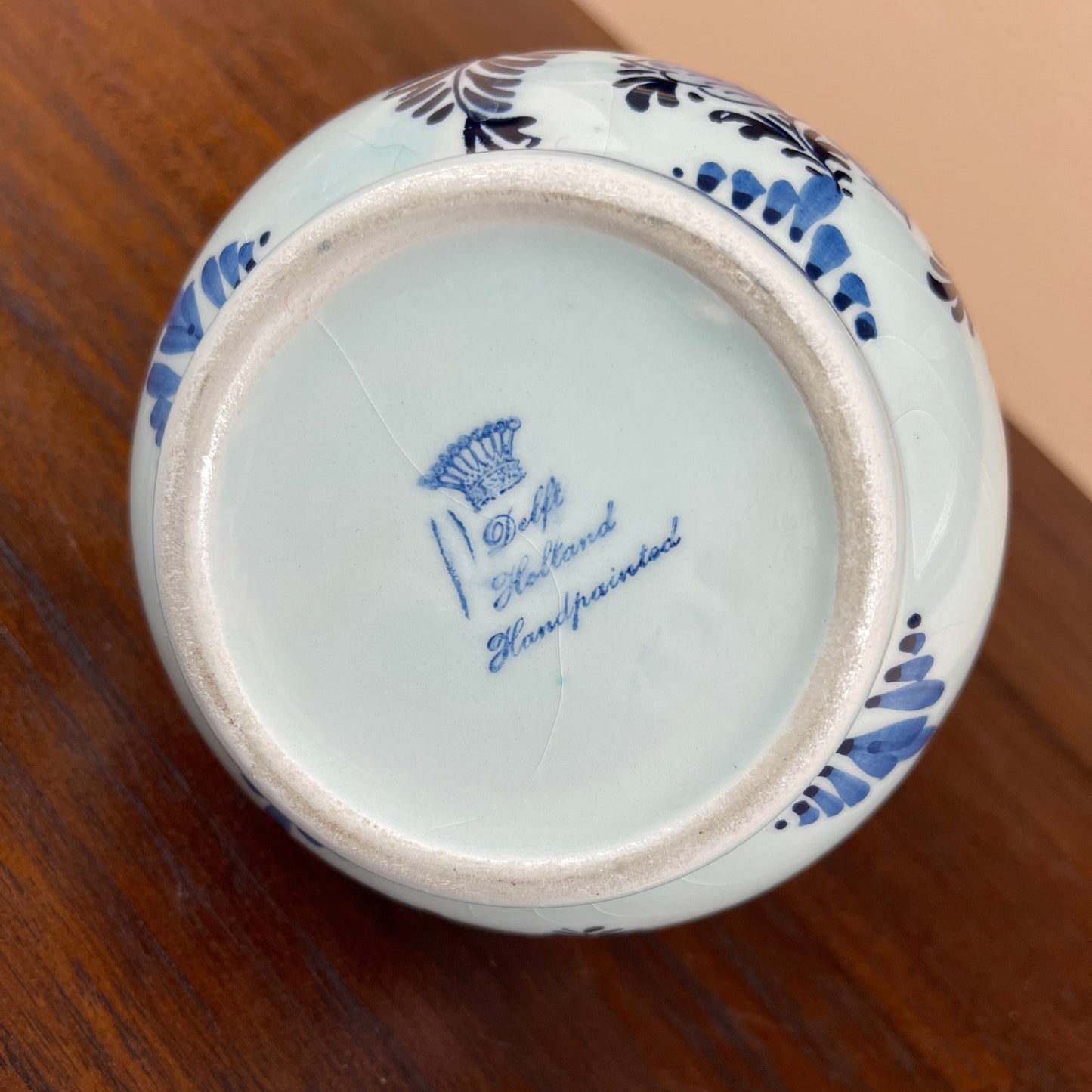 Ceramic jar with blue floral patterns on a wooden surface