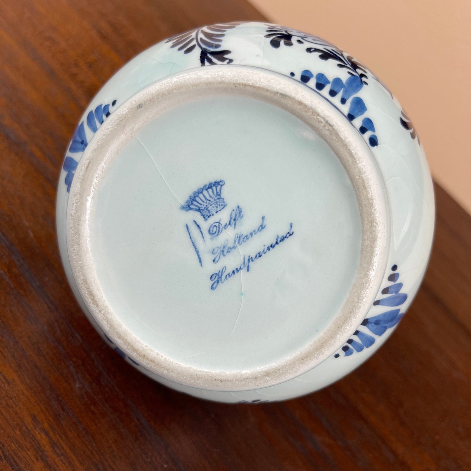 Ceramic jar with blue floral patterns on a wooden surface