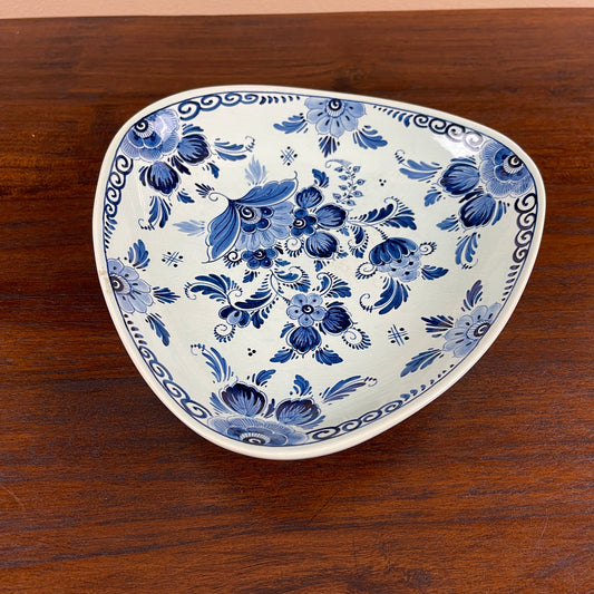 Ceramic plate with blue floral pattern on a wooden surface