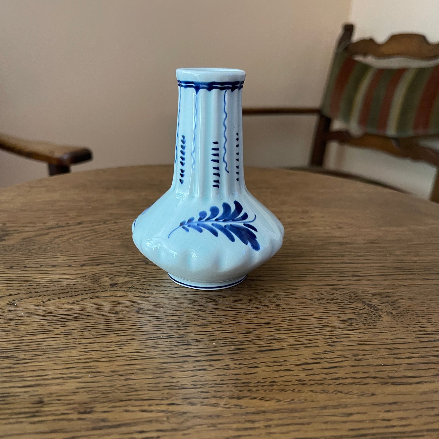 White vase with blue patterns on a wooden table
