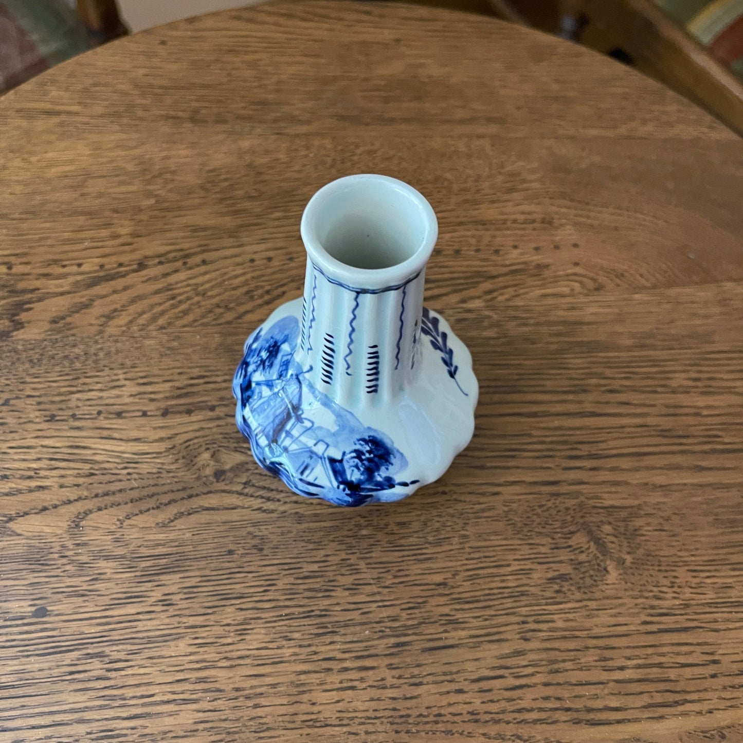 Blue and white ceramic vase on a wooden surface