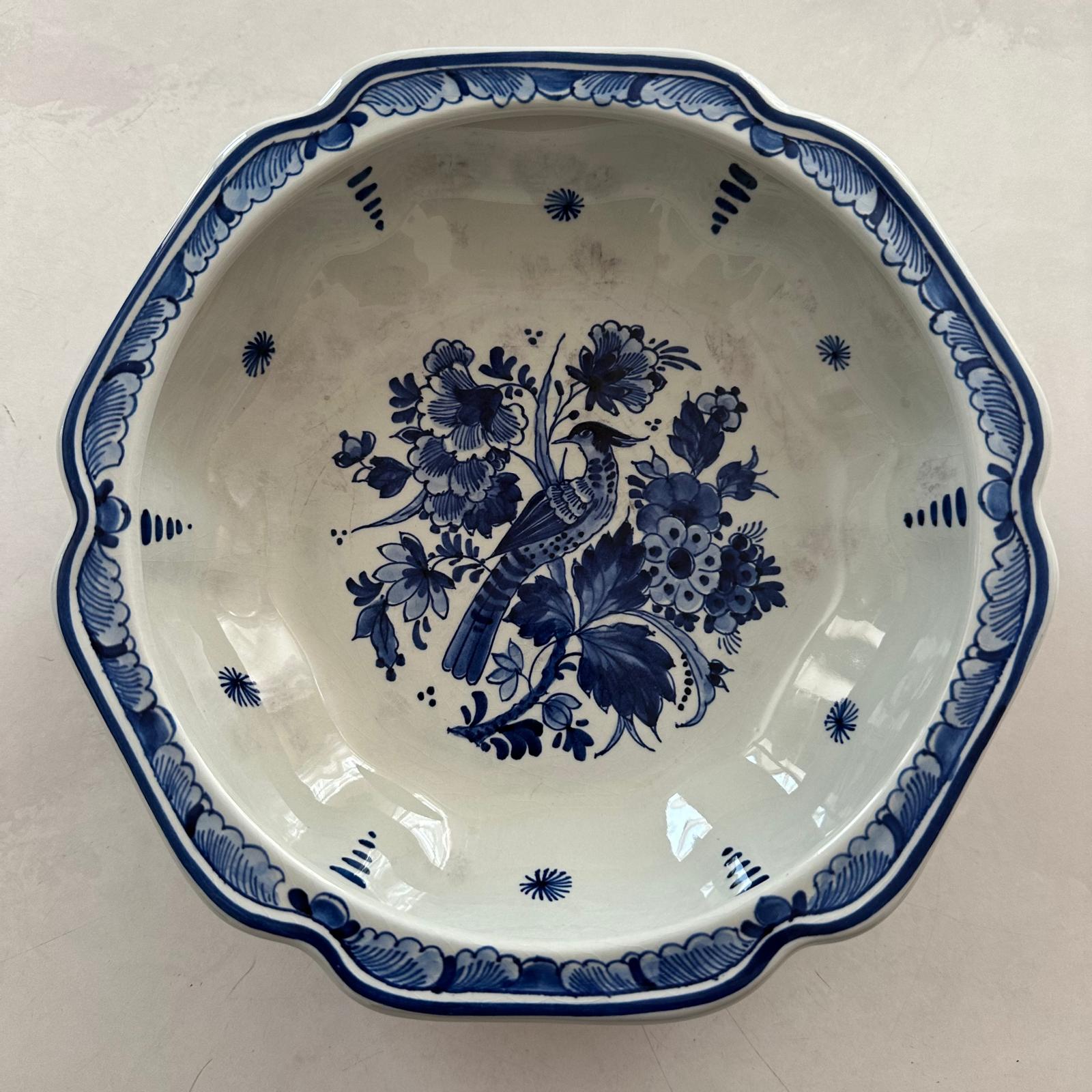 Ceramic plate with blue floral and bird design on a white background