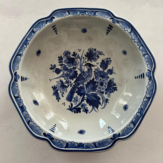 Ceramic plate with blue floral and bird design on a white background