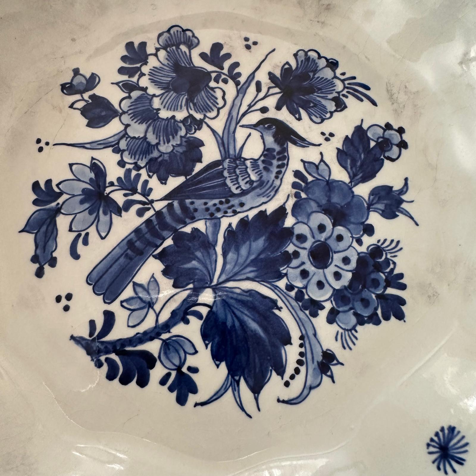 Decorative plate with blue floral and bird design on a white background