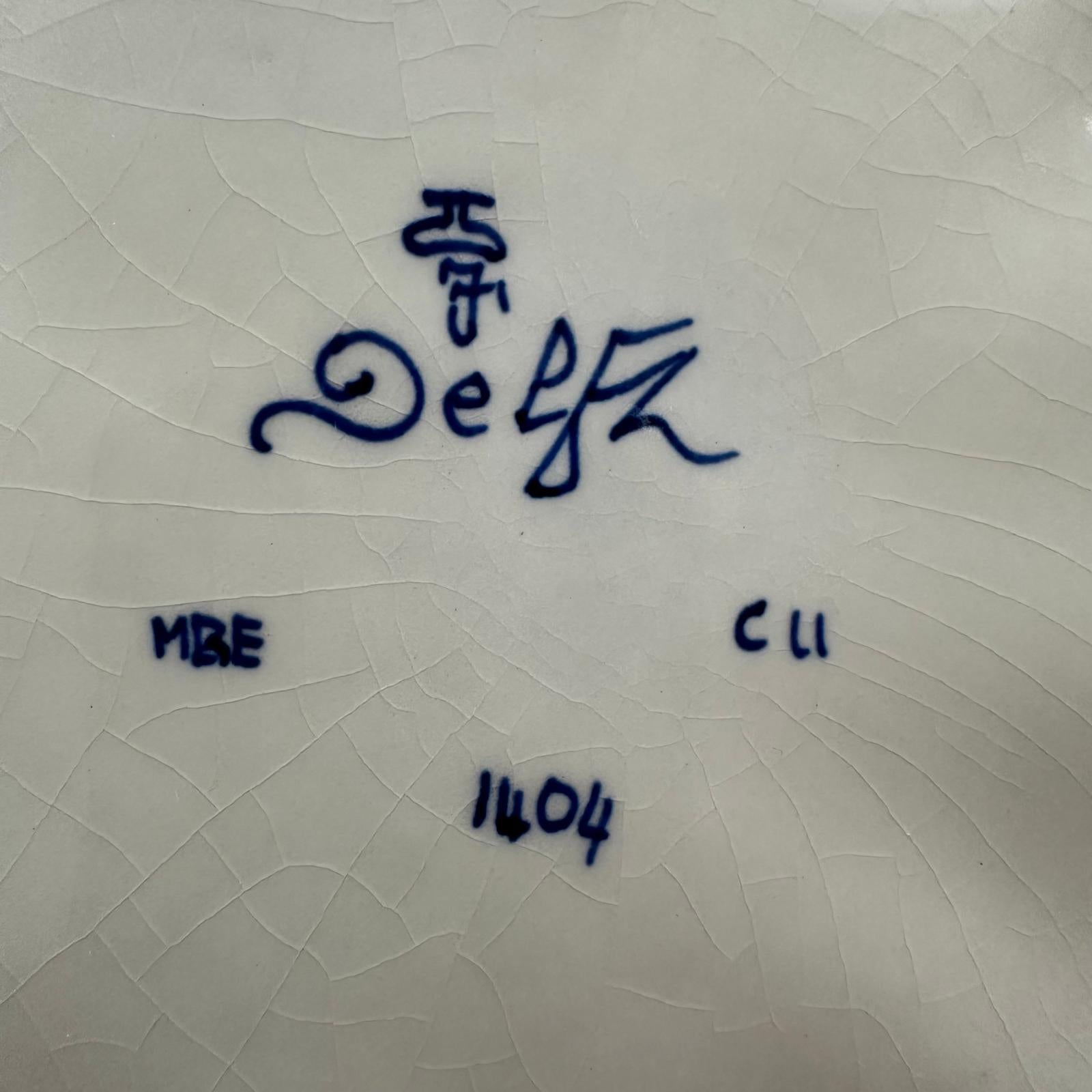 Signature on a textured white surface with 'Delva' written in blue ink.