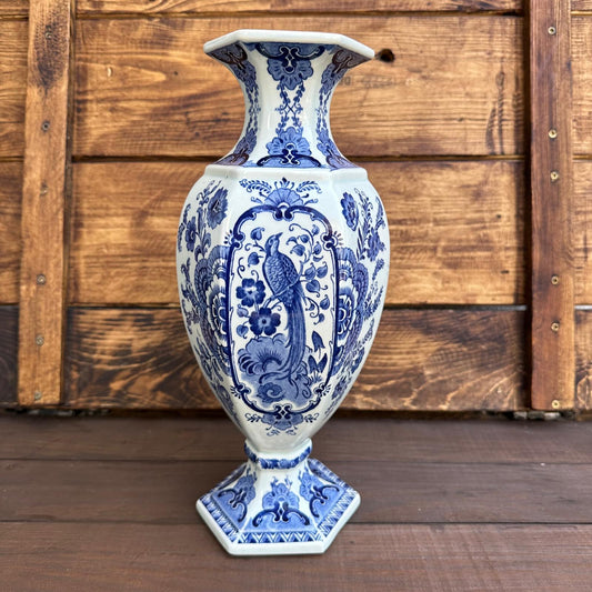 Blue and white ceramic vase with intricate patterns on a wooden background