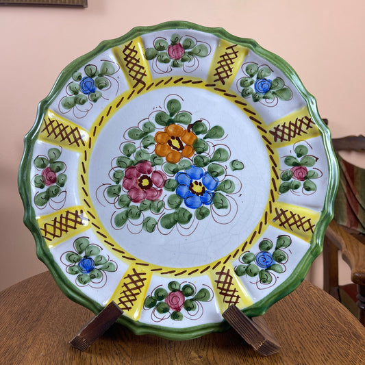 Decorative plate with floral patterns on a wooden surface
