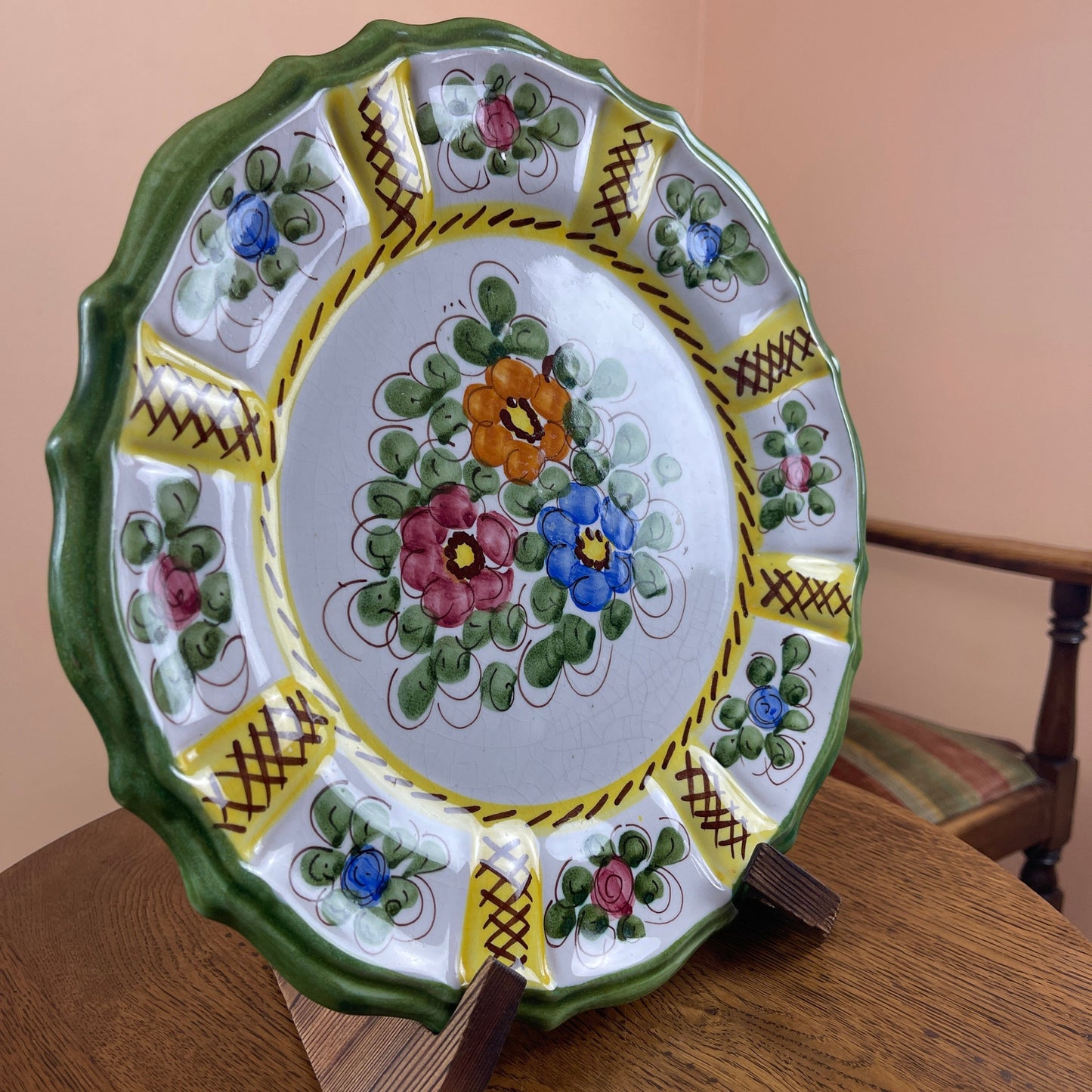 Decorative ceramic plate with floral patterns on a wooden surface