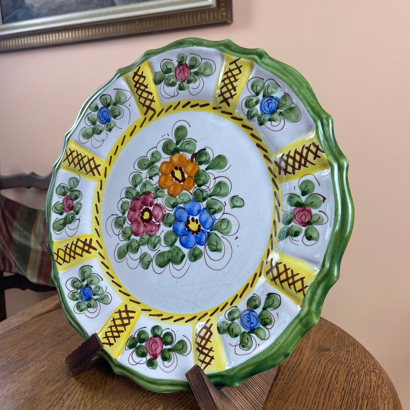 Decorative ceramic plate with floral patterns on a wooden surface