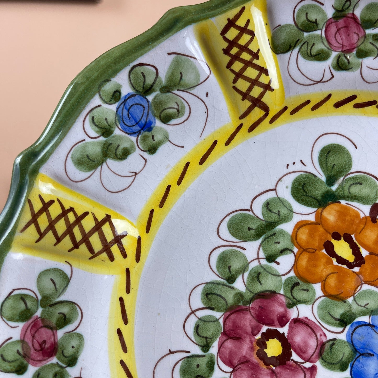 Decorative ceramic plate with floral patterns and a yellow border
