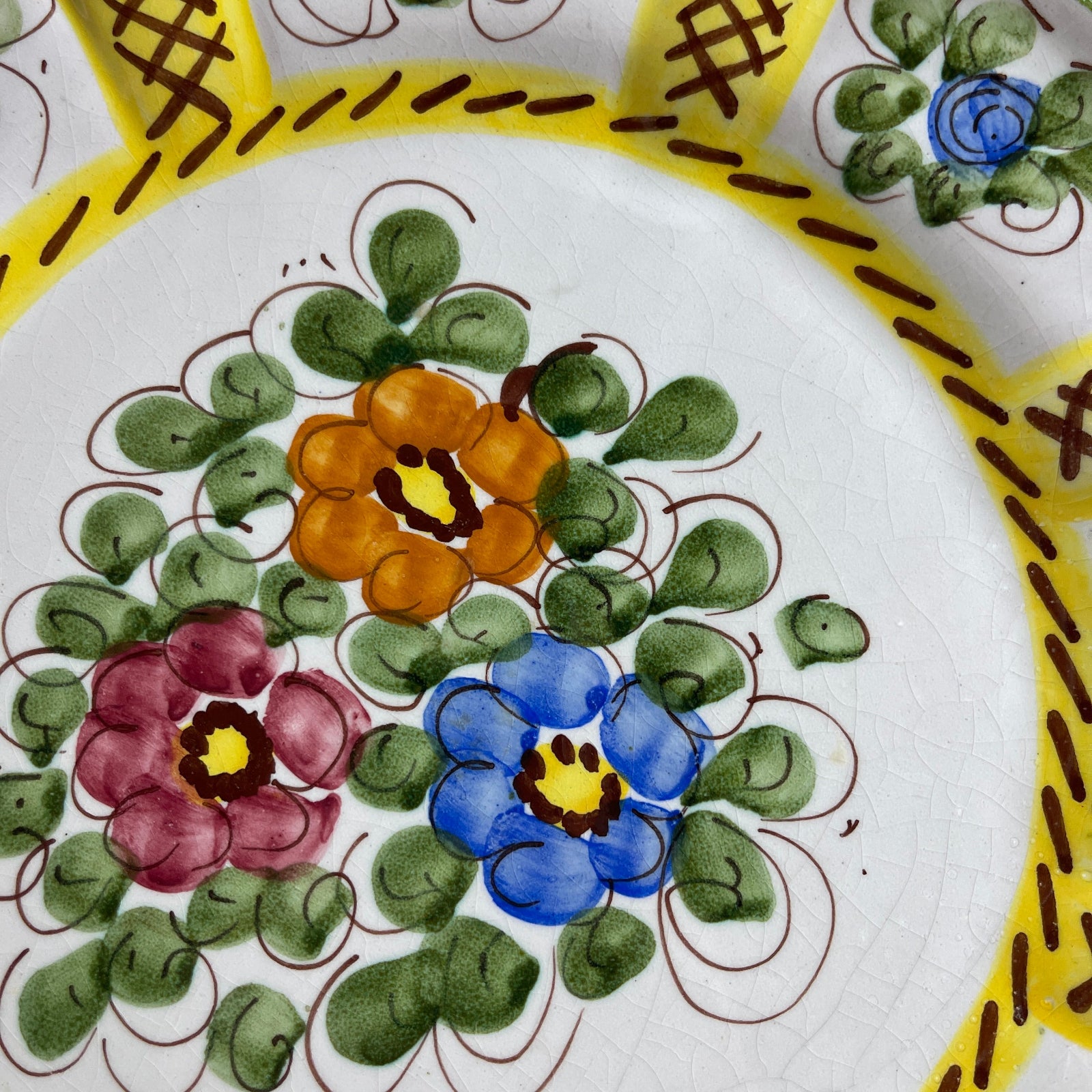 Decorative plate with floral patterns and yellow border