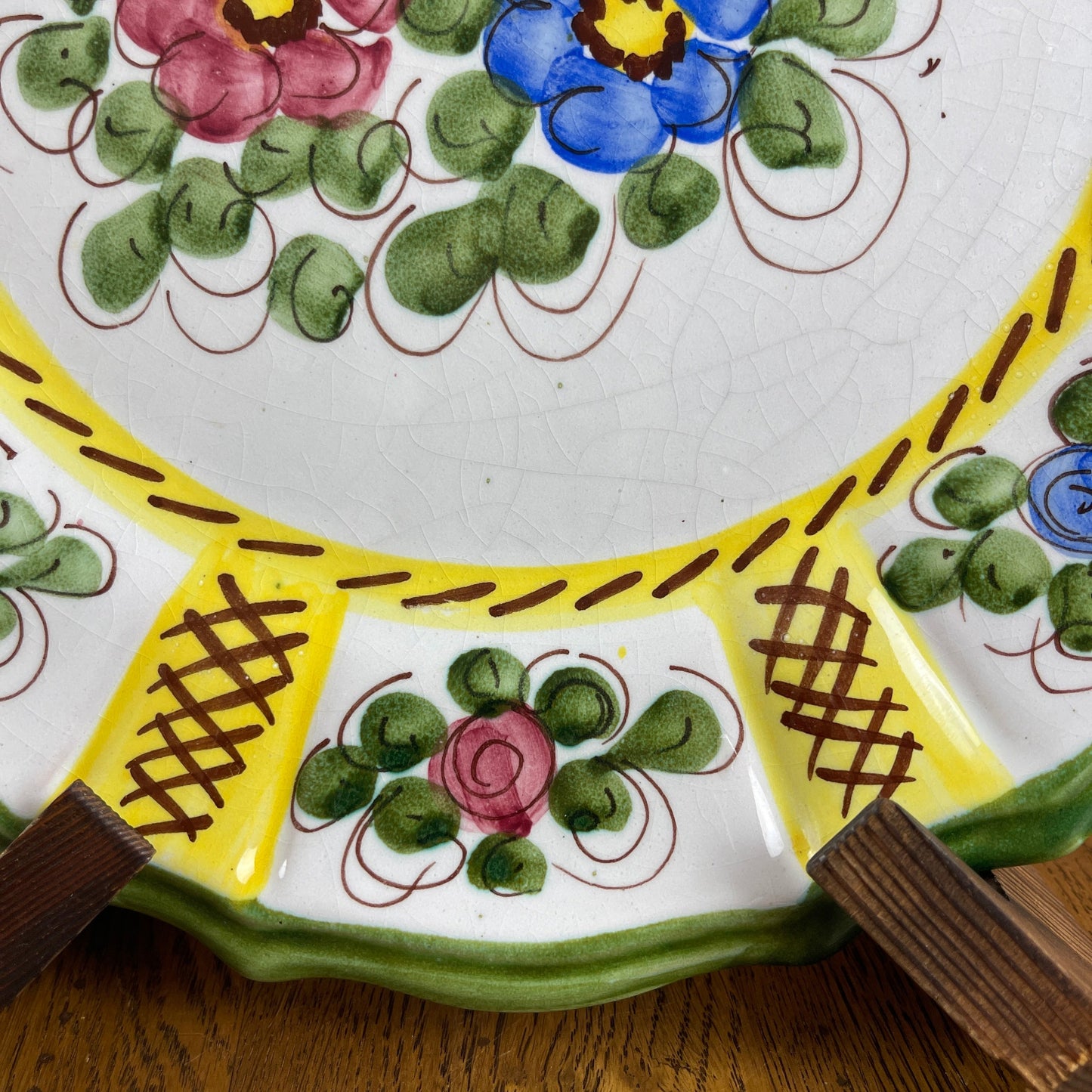 Decorative ceramic plate with floral patterns on a wooden surface