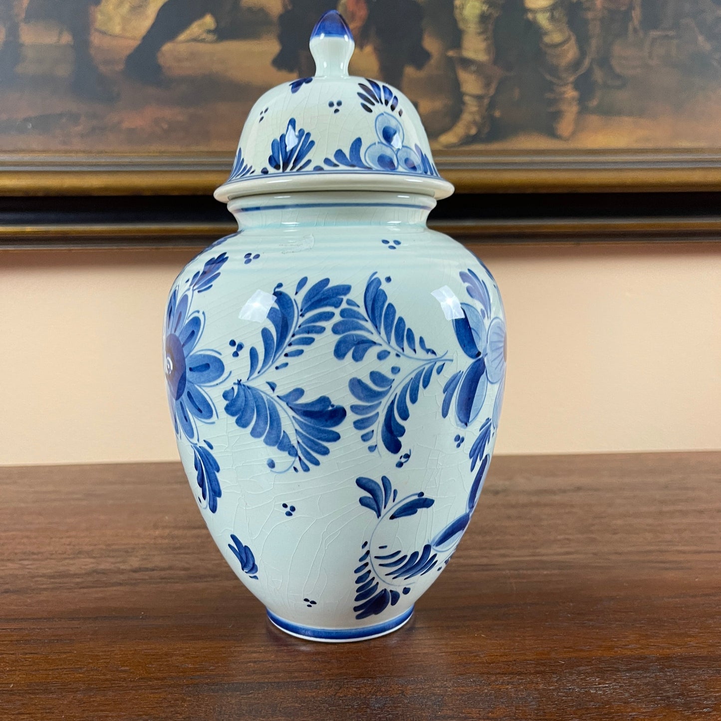 Blue and white ceramic jar with floral patterns on a wooden surface