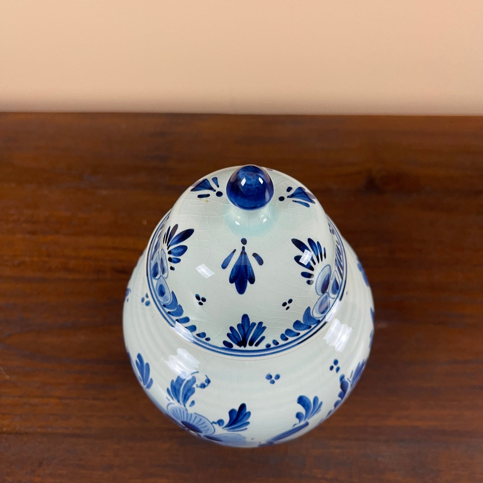 Ceramic container with blue floral patterns on a wooden surface