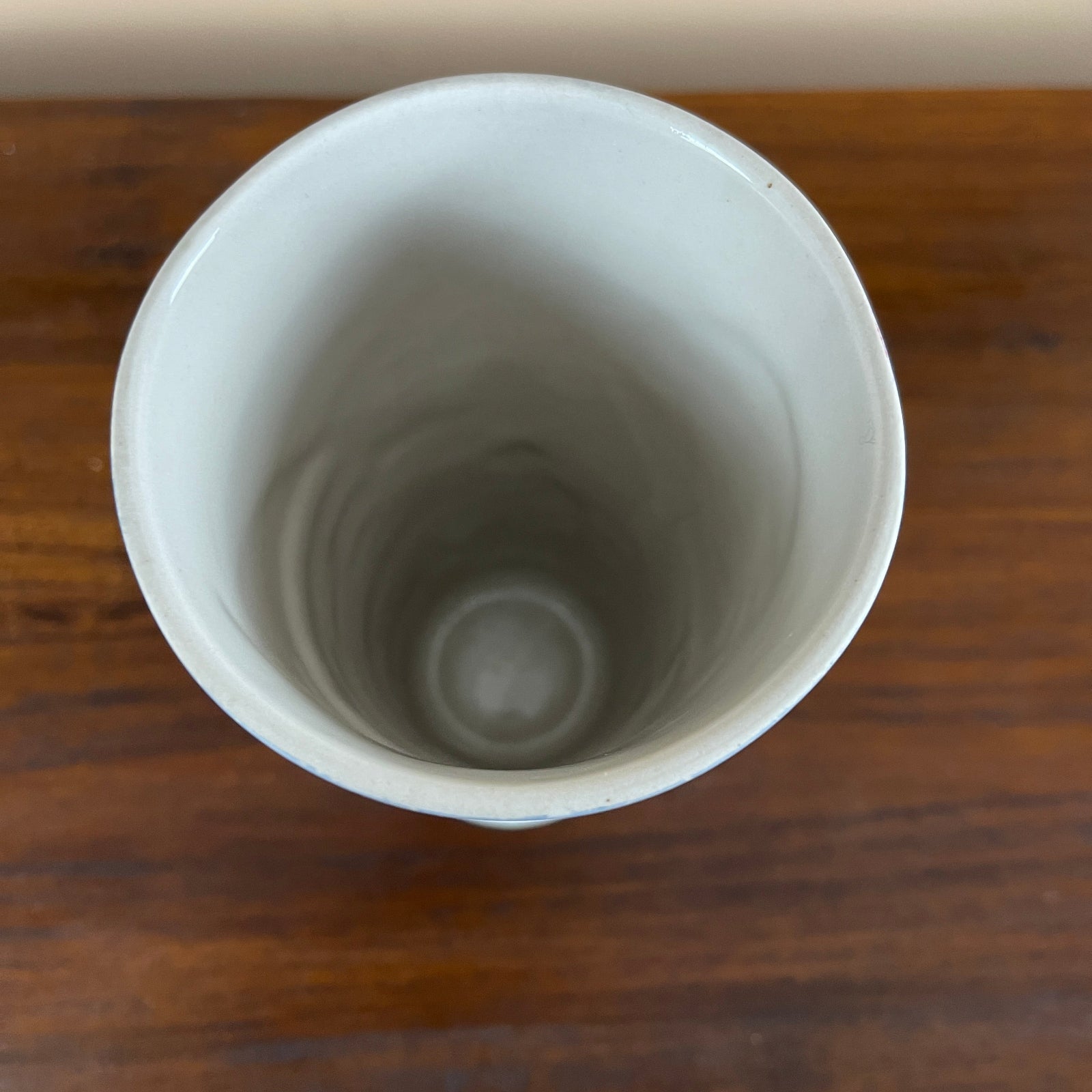White ceramic cup on a wooden surface