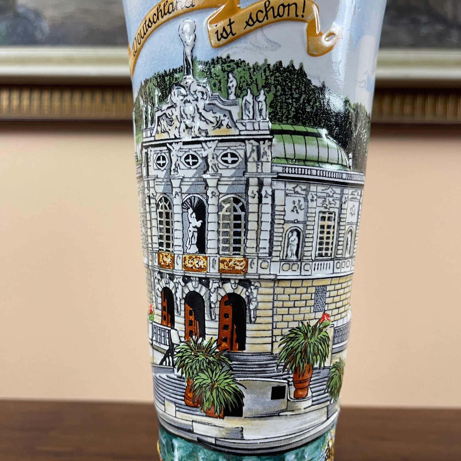 Decorative glass with architectural design and text on a neutral background