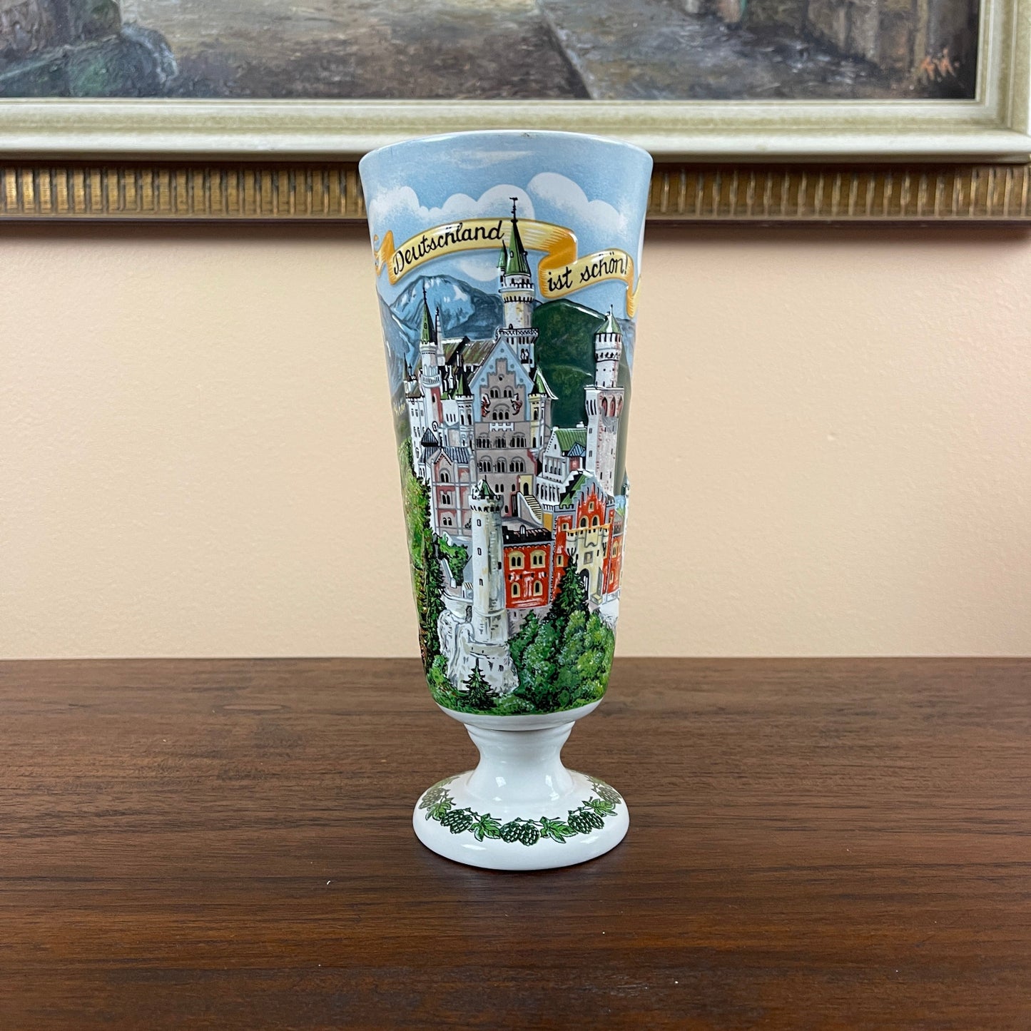 Decorative glass with a castle design on a wooden surface