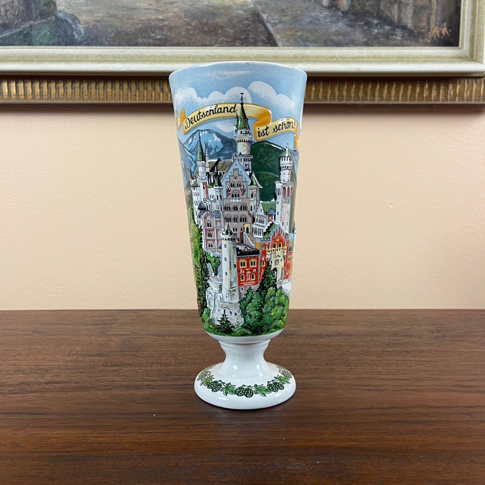 Decorative glass with a castle design on a wooden surface