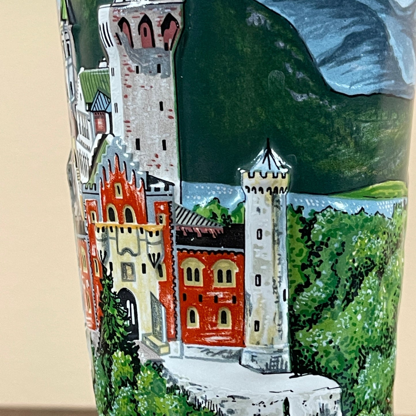 Decorative tile with a castle design and mountain background