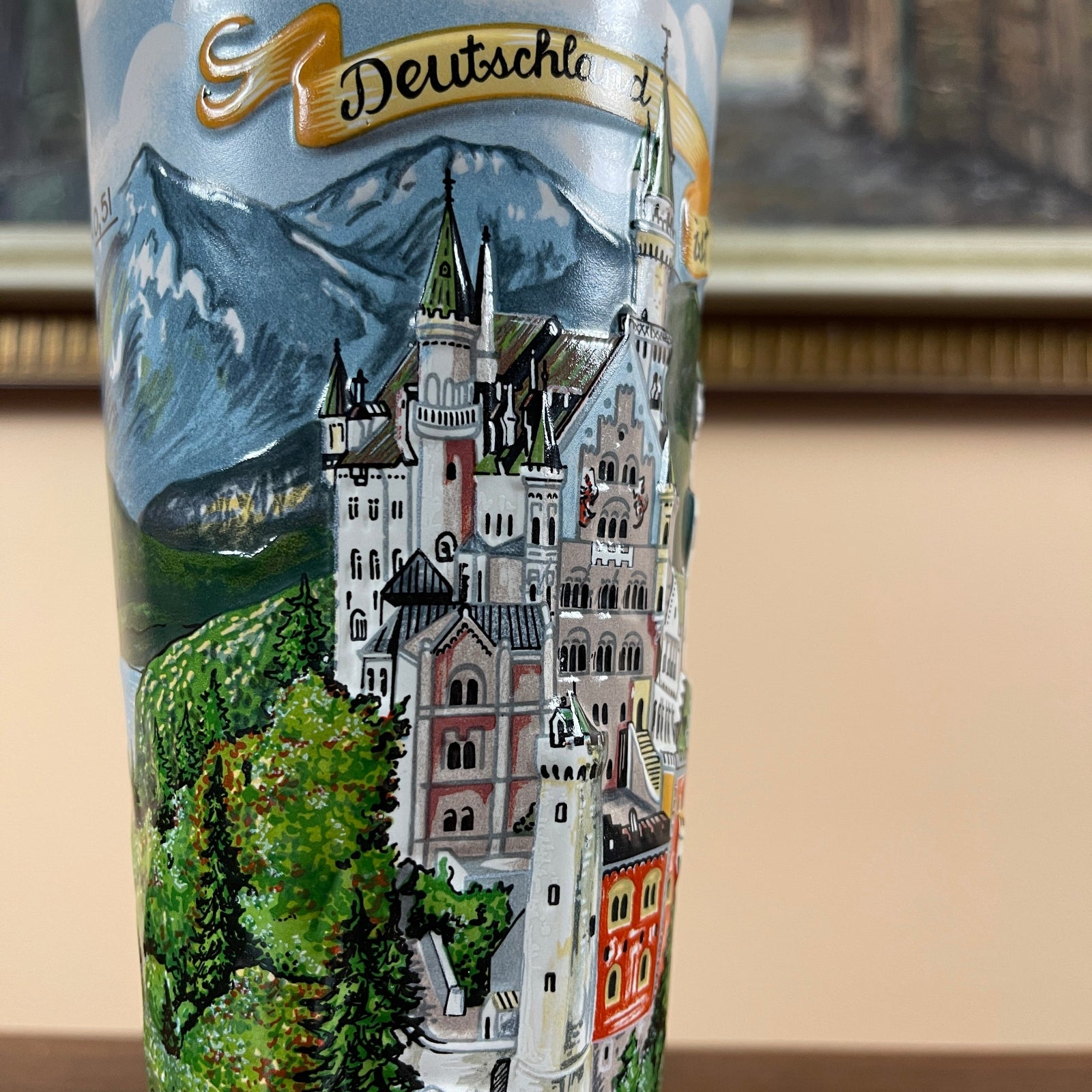 Tumbler with a castle and mountain design, featuring the word 'Deutschland'.