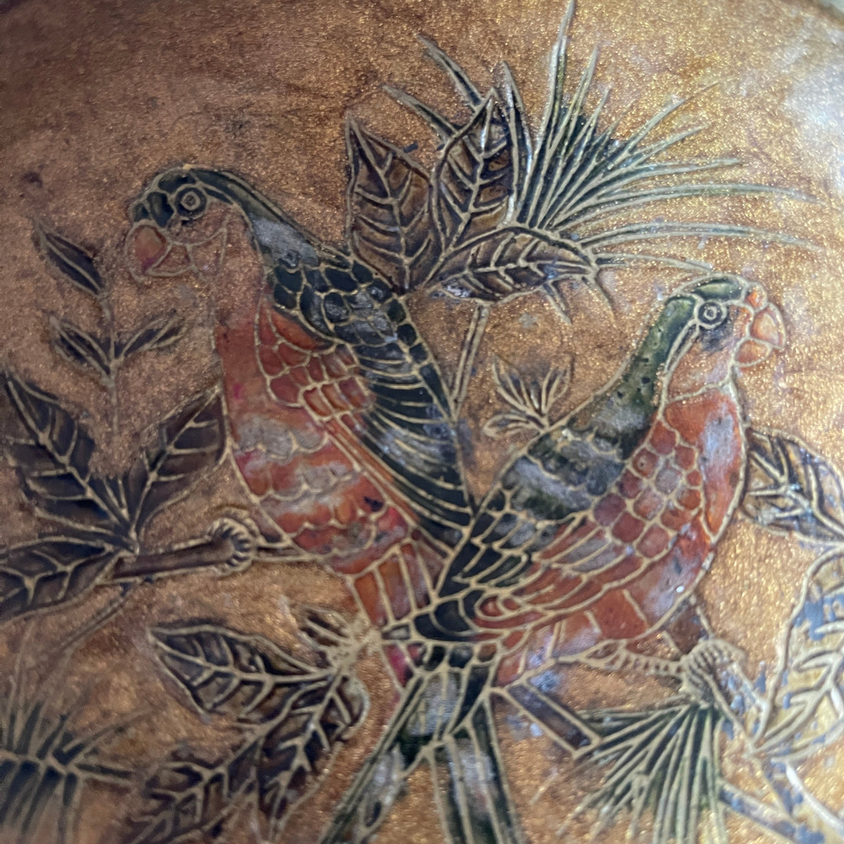 Decorative tile with stylized birds and leaves on a textured background