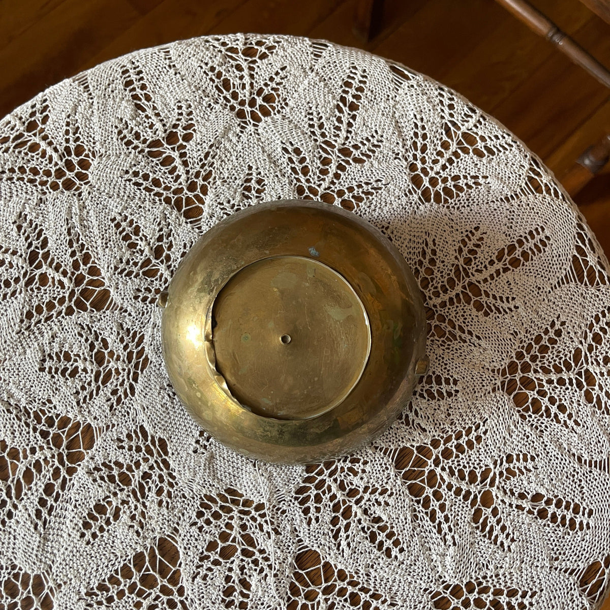 Brass bowl on a lace tablecloth