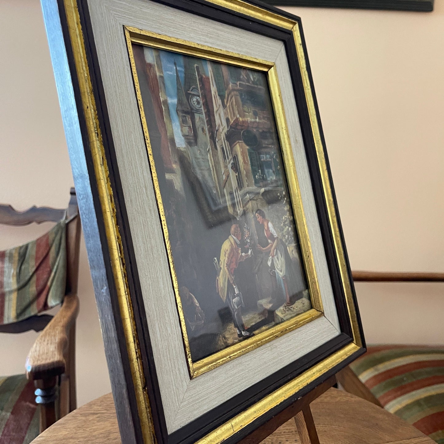 Framed artwork on a stand with a blurred background