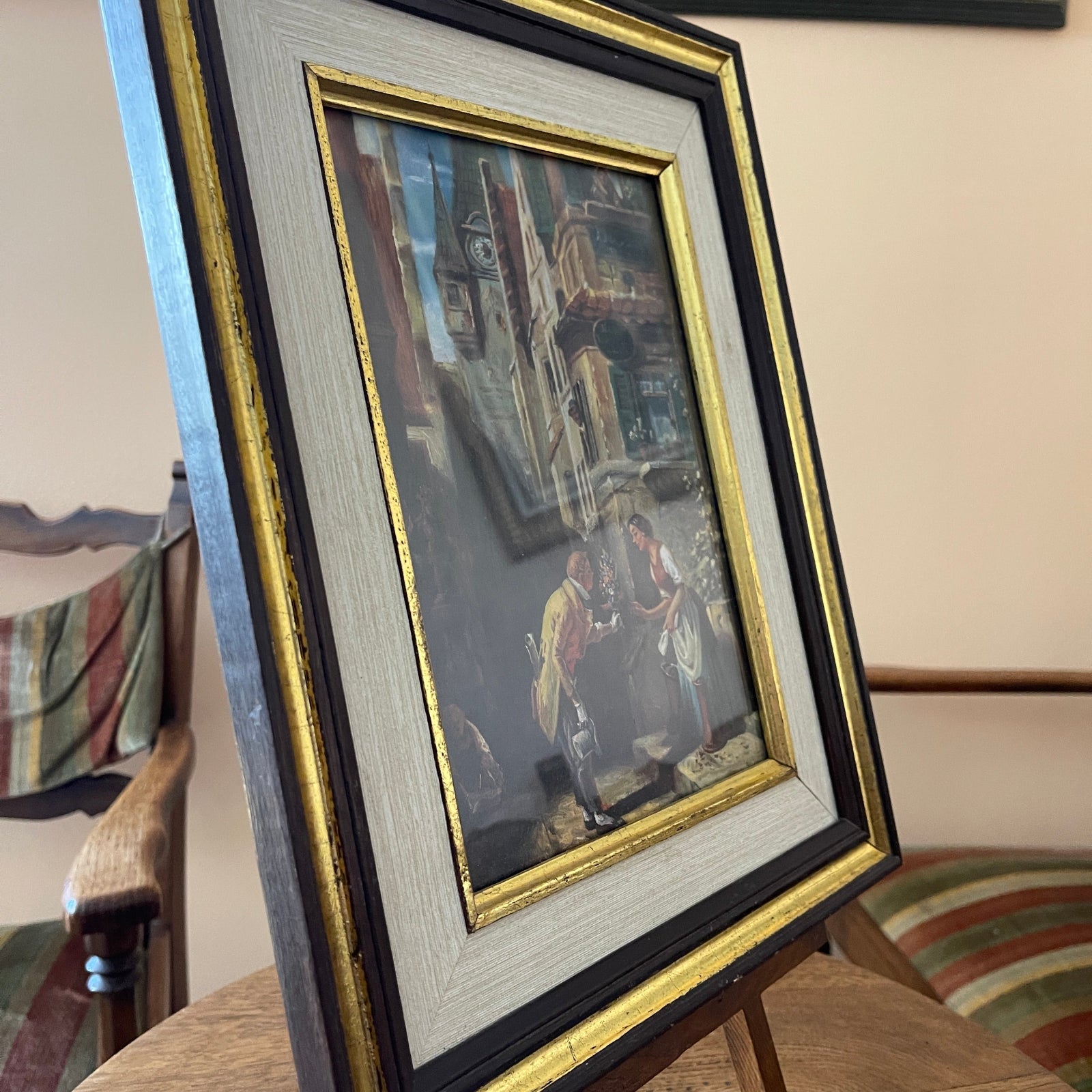 Framed artwork on a stand with a blurred background