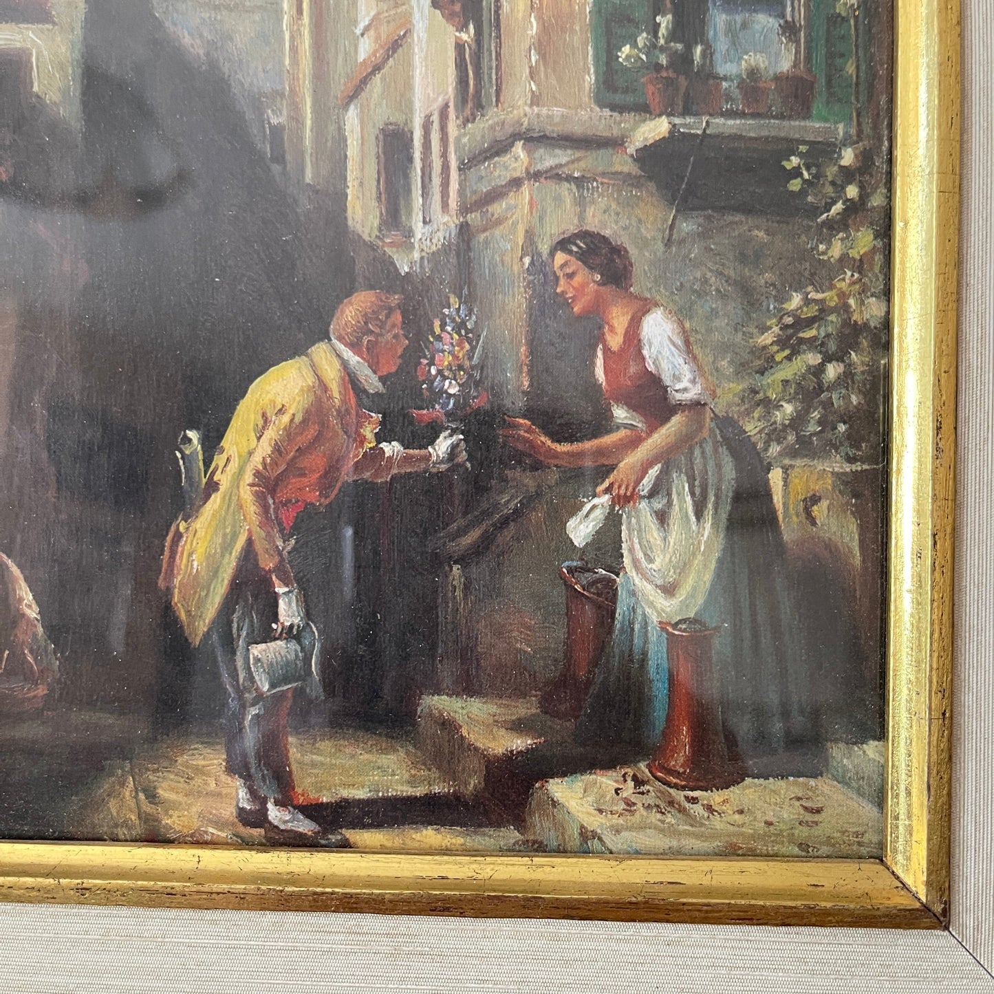 Painting of a man and woman exchanging flowers outdoors with a gold frame.