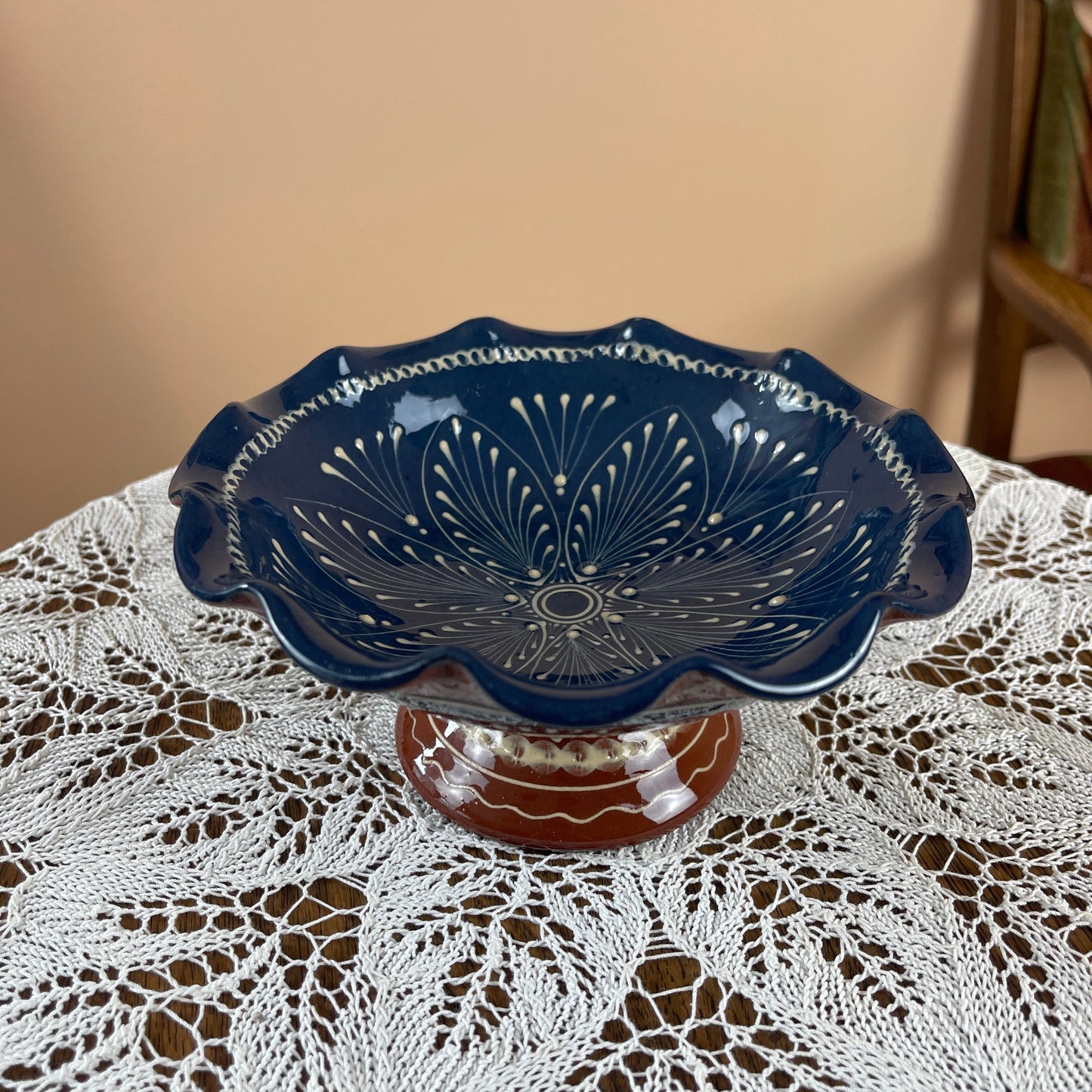 Decorative blue ceramic bowl on a lace tablecloth