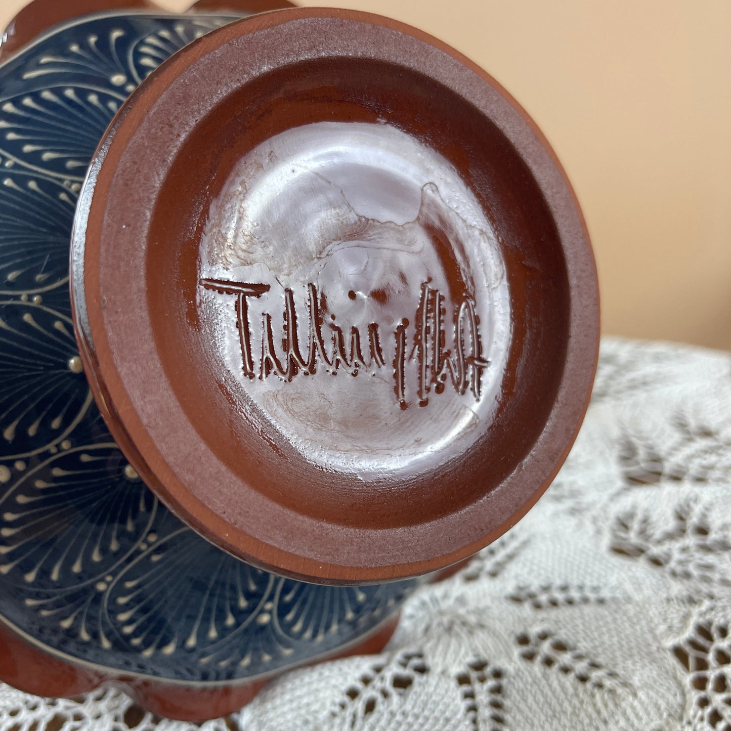 Close-up of a ceramic product with 'Talavera' branding on a textured surface.