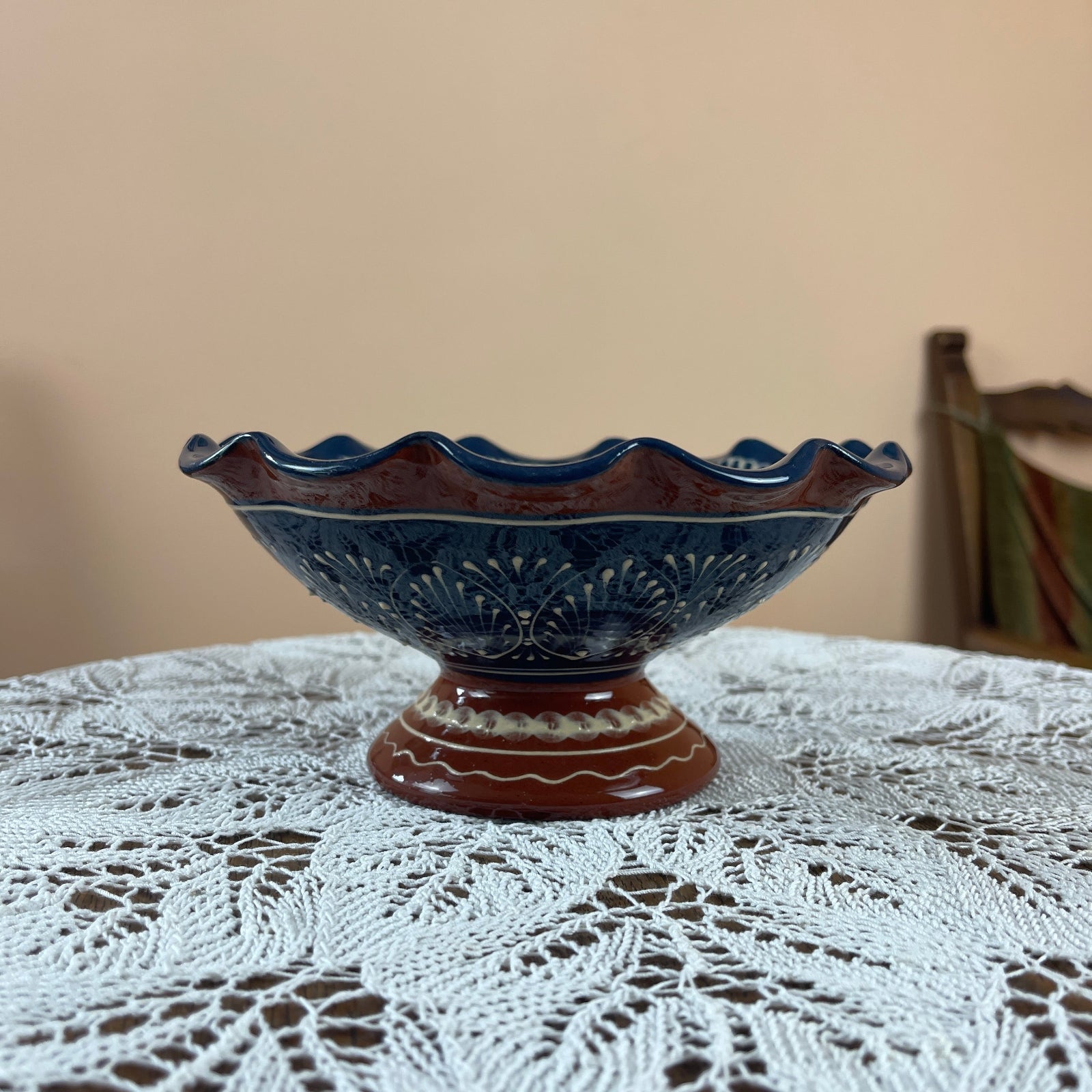 Decorative ceramic bowl on a lace tablecloth with a neutral background