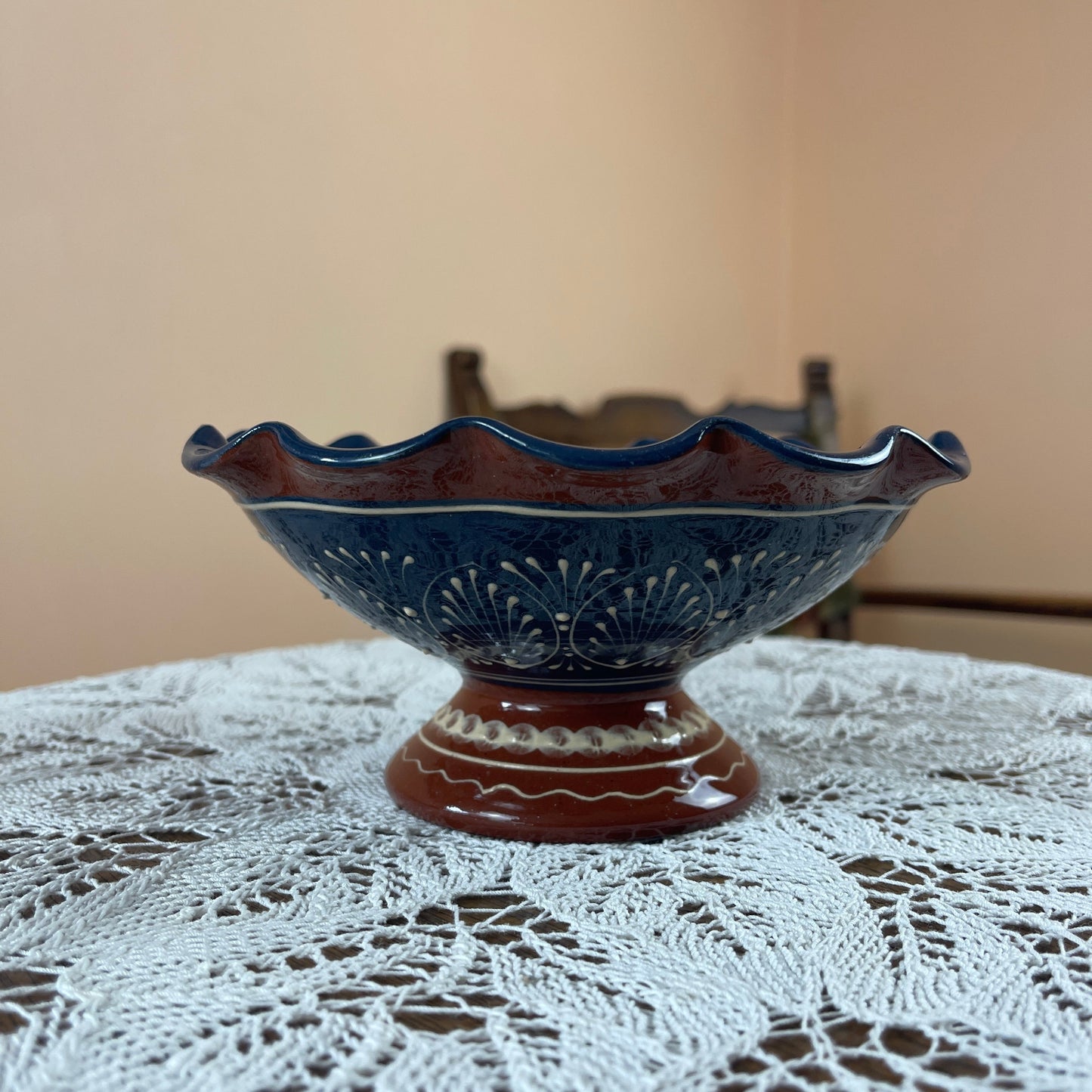 Decorative ceramic bowl on a lace tablecloth with a neutral background