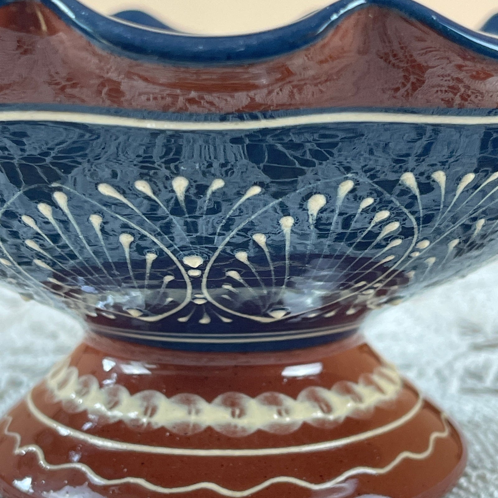 Decorative ceramic bowl with blue and brown design on a white background