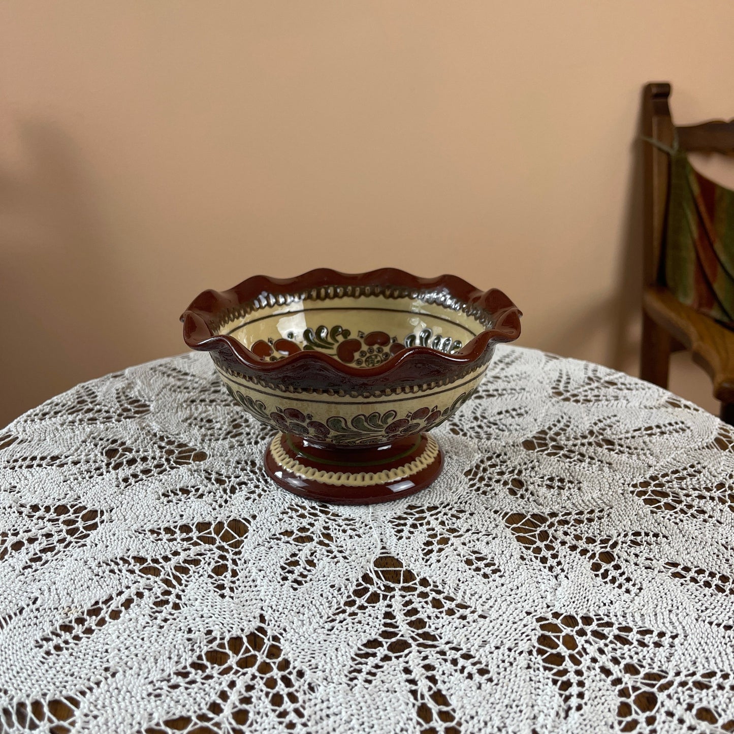 Decorative ceramic bowl on a lace tablecloth with a blurred background