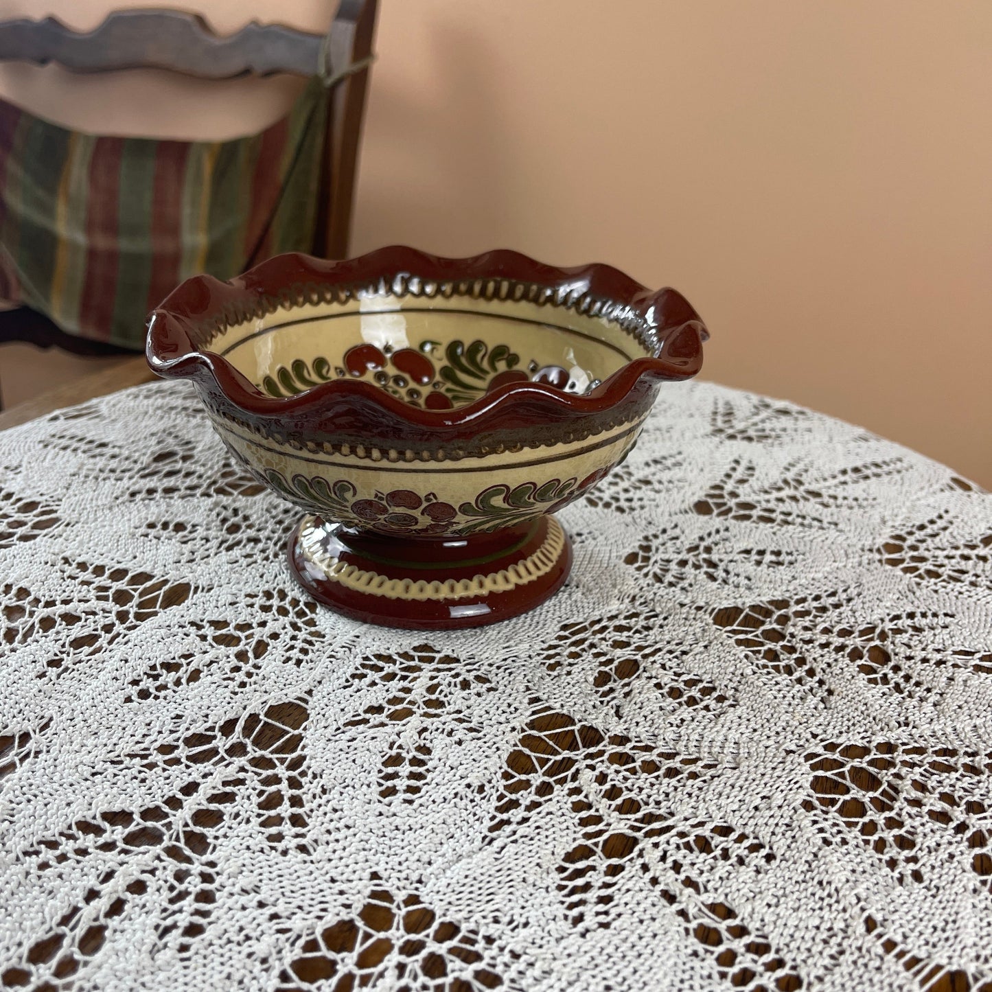Decorative ceramic bowl on a lace tablecloth with a blurred background
