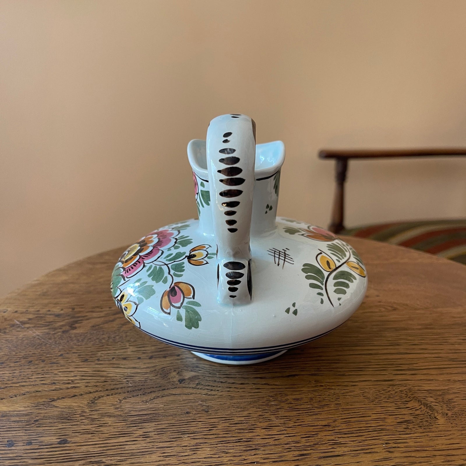 Decorative ceramic object with floral patterns on a wooden surface