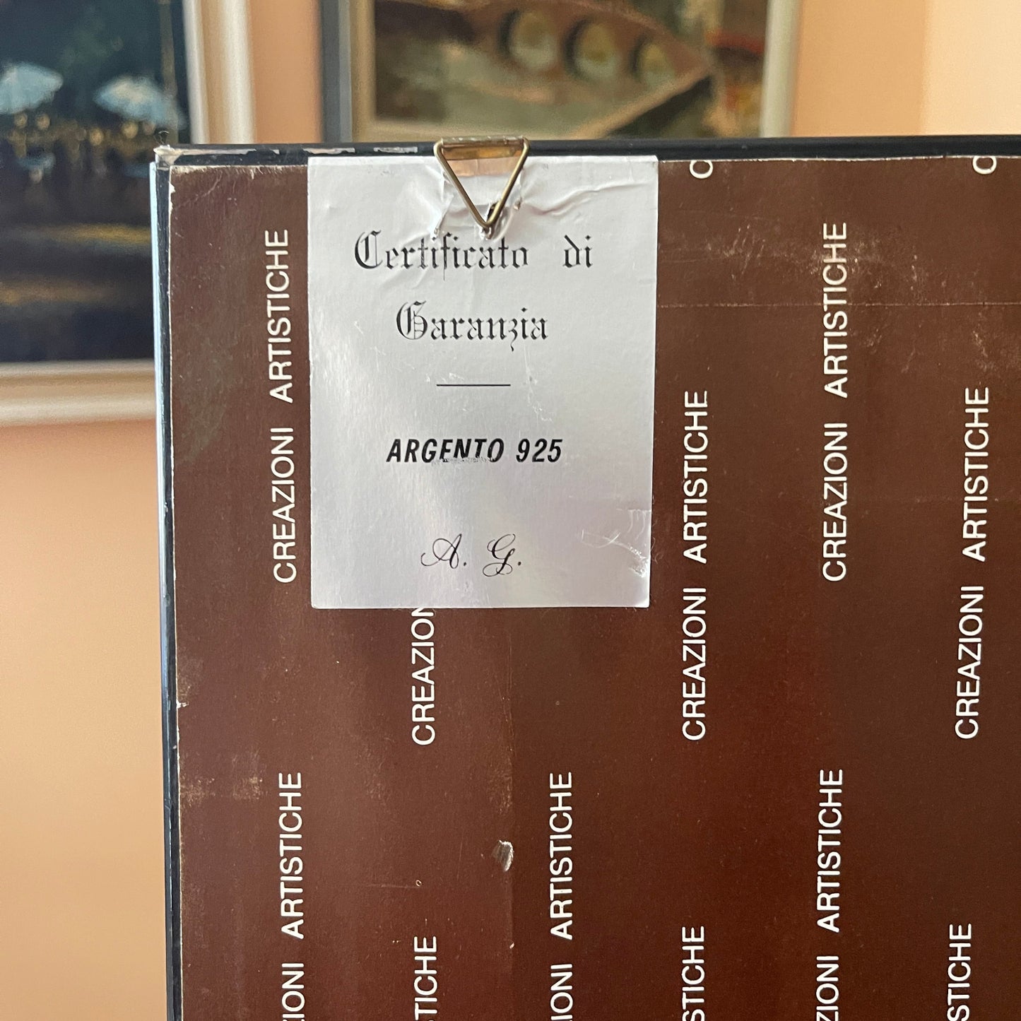 Brown box with 'Creazioni Artistiche' branding and a silver certificate inside.