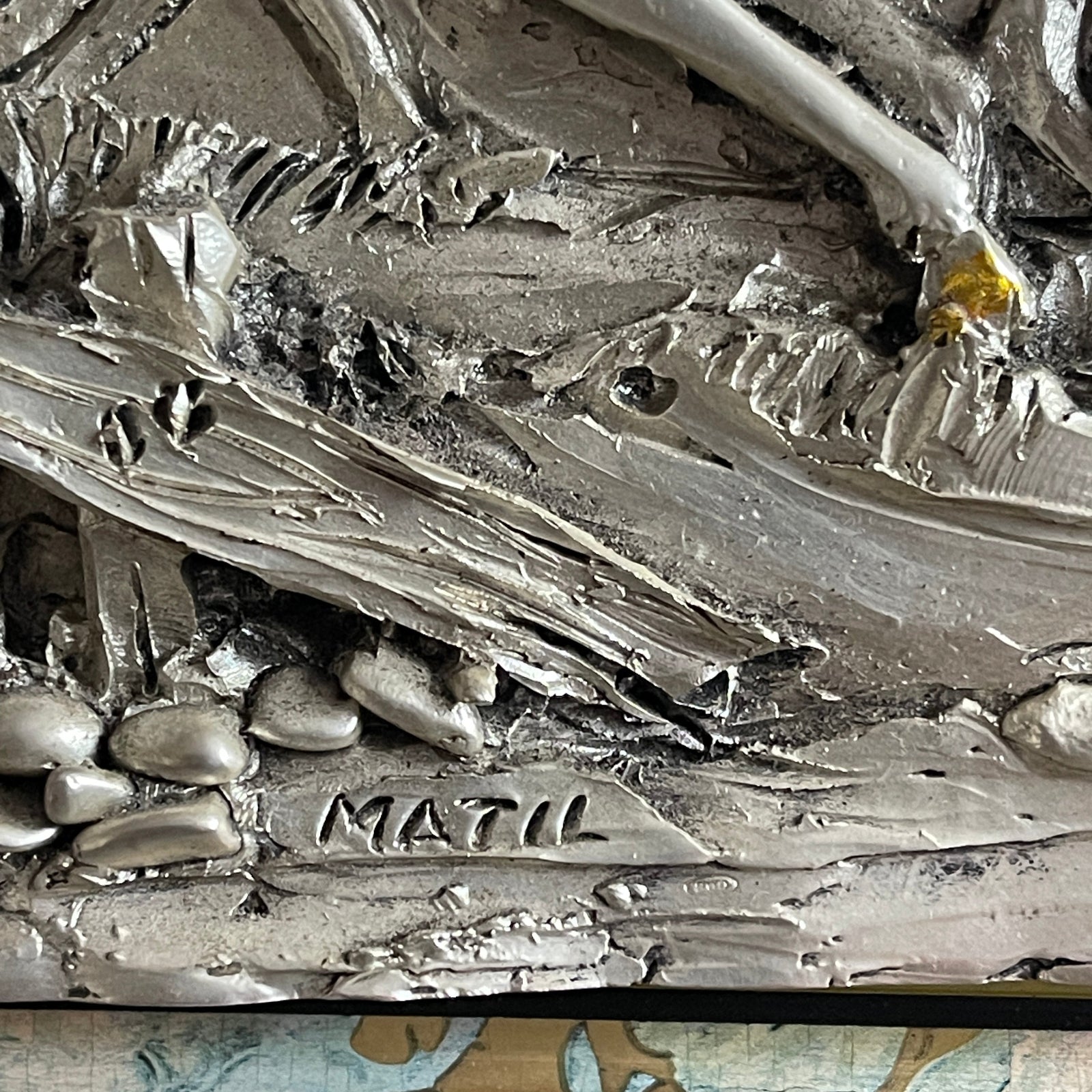 Close-up of a textured surface with 'MATIL' branding.