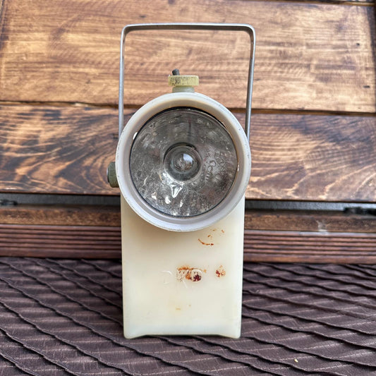 Vintage camping lantern on a wooden surface
