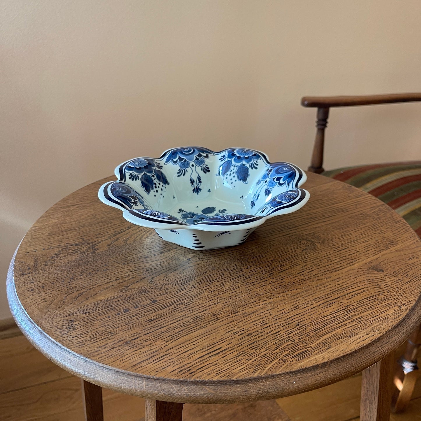 Decorative ceramic bowl with blue floral patterns on a wooden table.