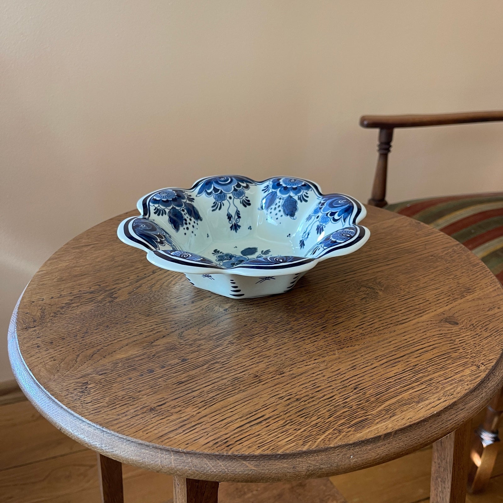 Decorative ceramic bowl with blue floral patterns on a wooden table.