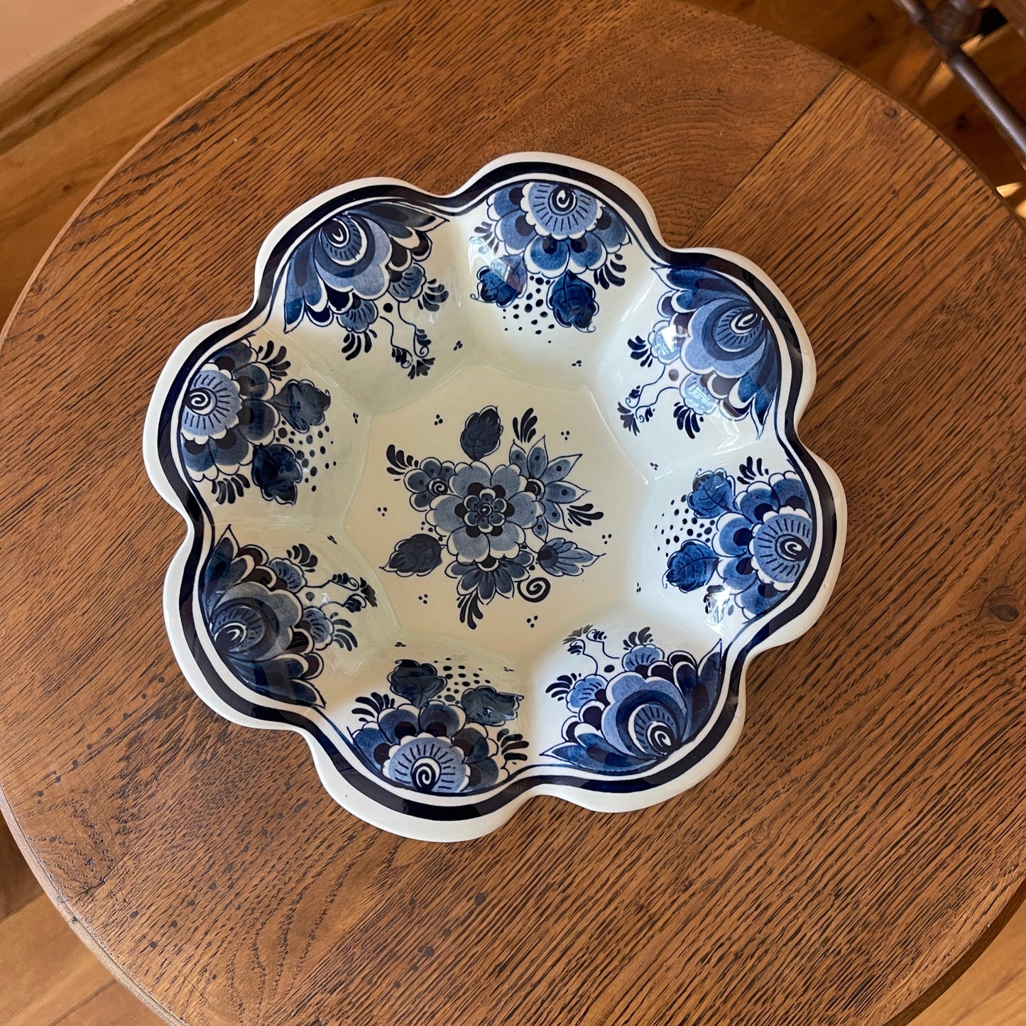Decorative ceramic plate with blue floral patterns on a wooden surface