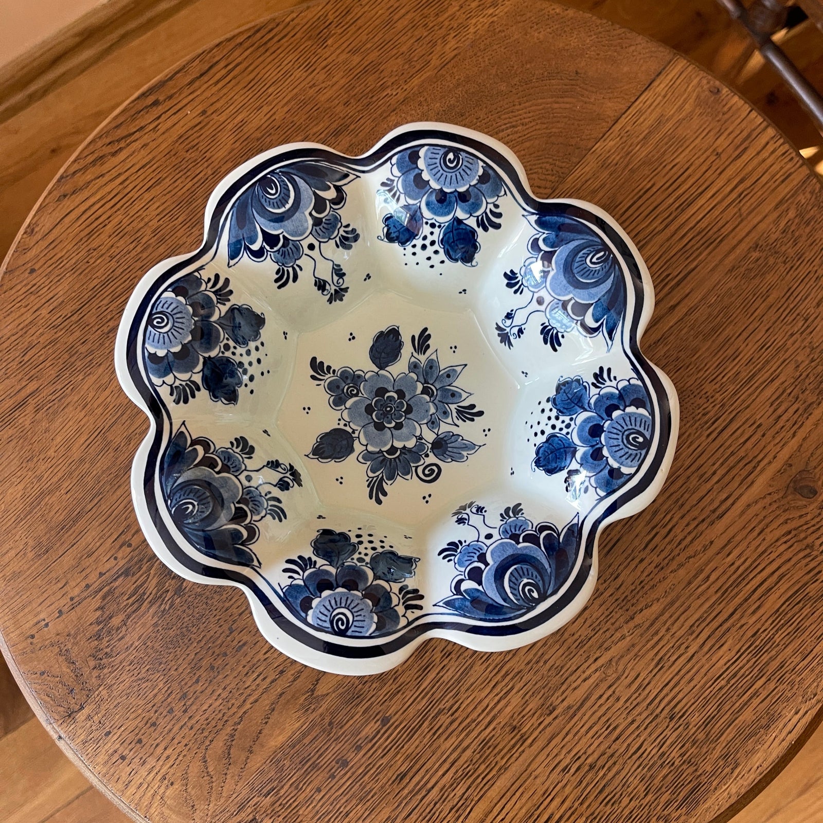 Decorative ceramic plate with blue floral patterns on a wooden surface