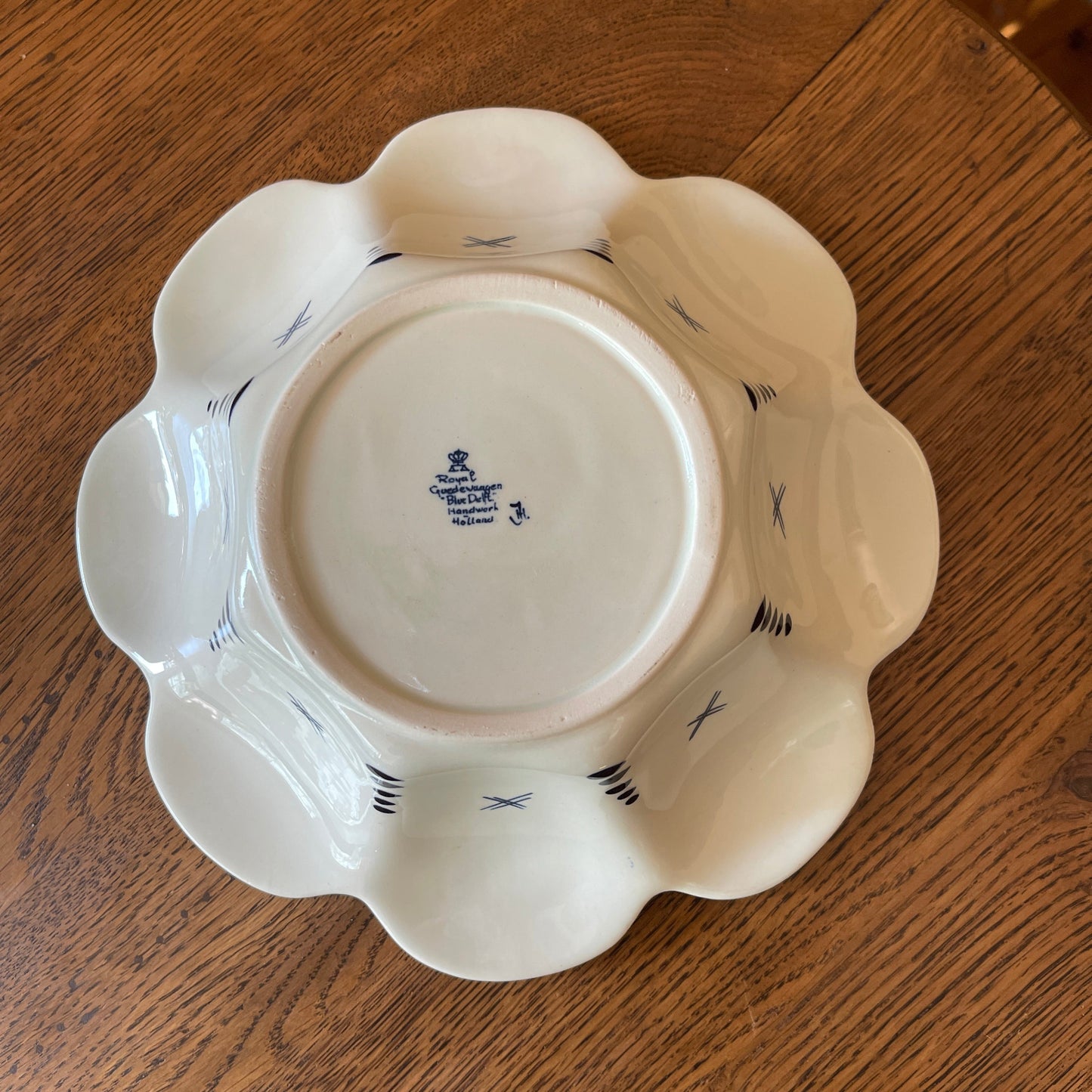 White ceramic plate with blue patterns on a wooden surface