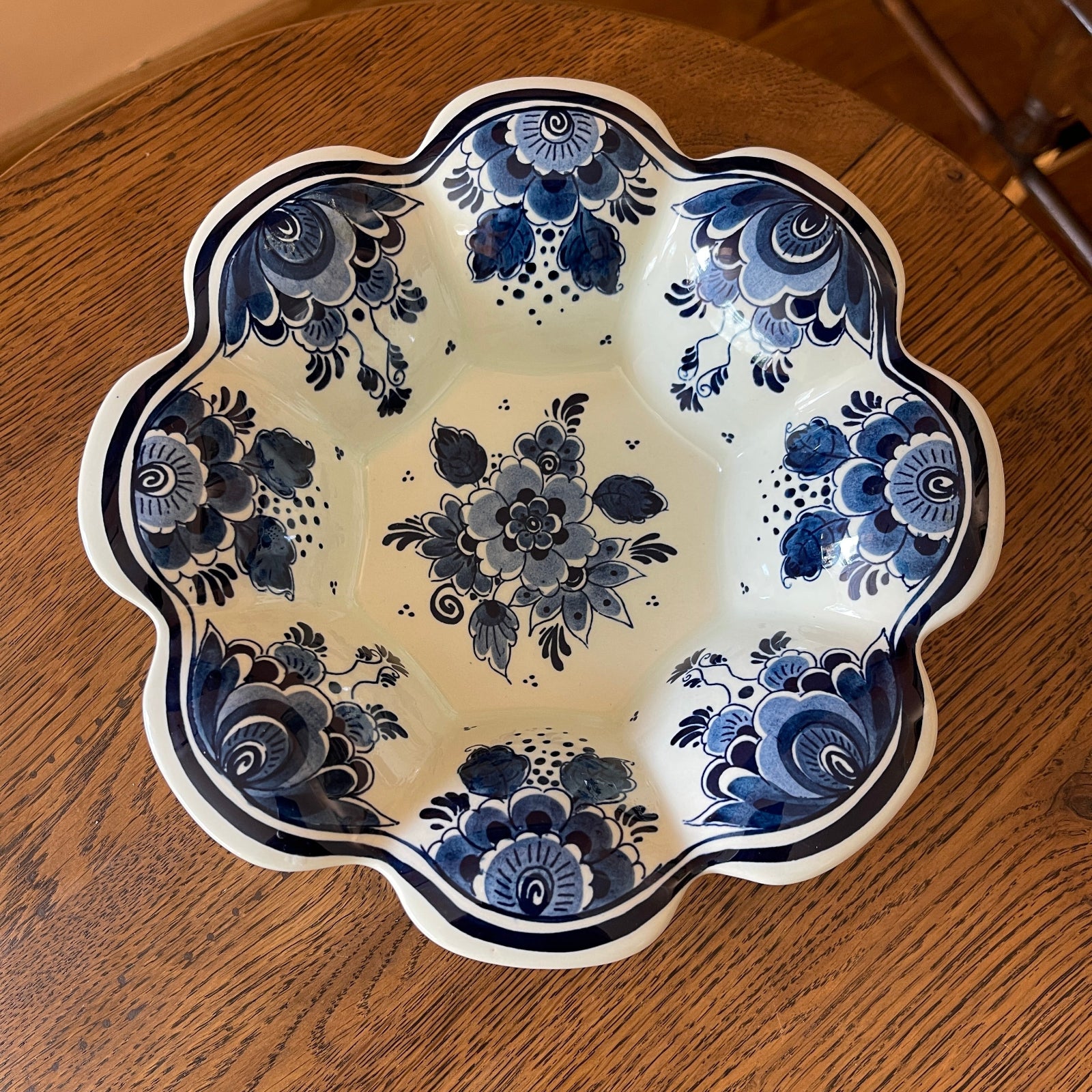 Decorative ceramic plate with blue floral patterns on a wooden surface