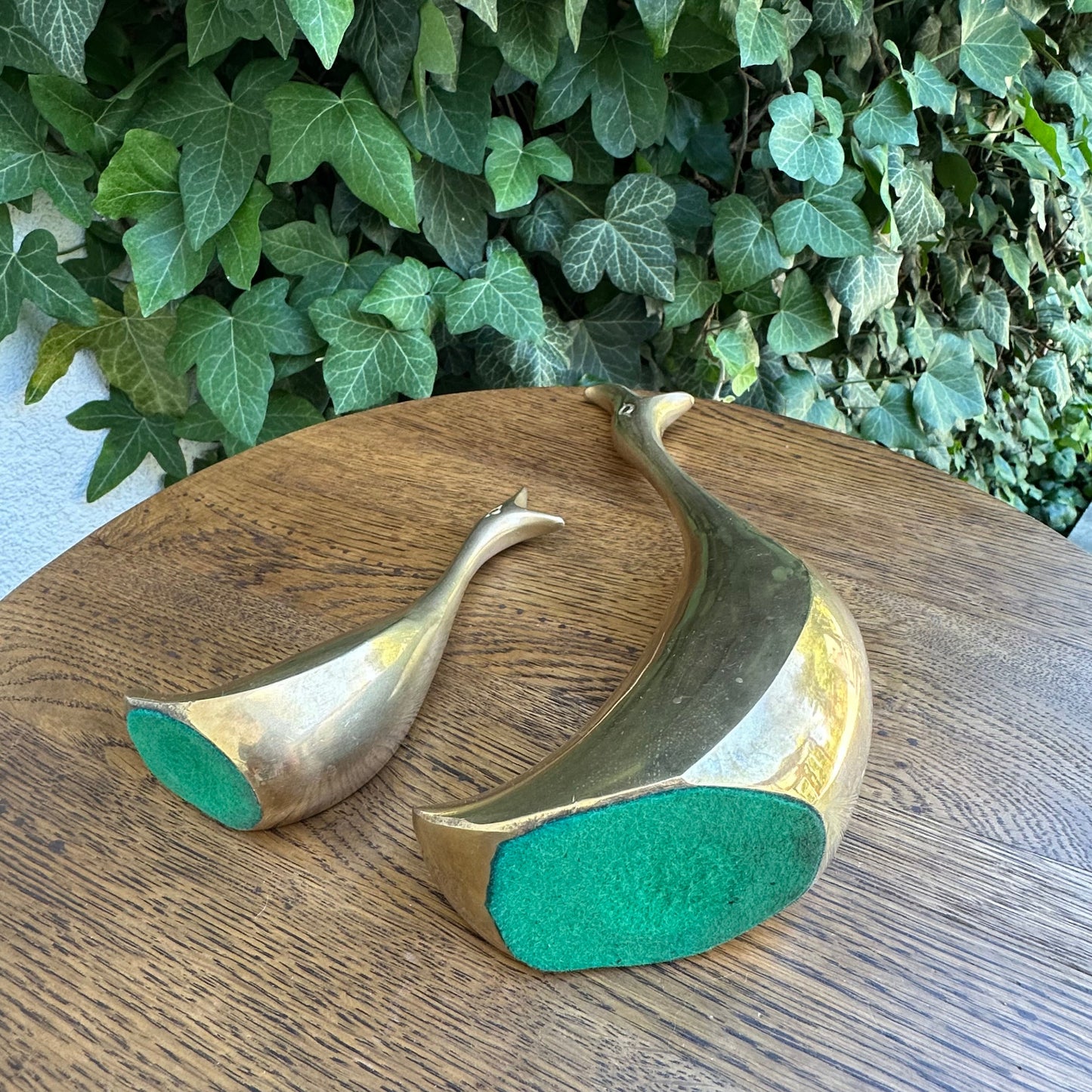 Decorative item with gold and green base on a wooden surface with a leafy background