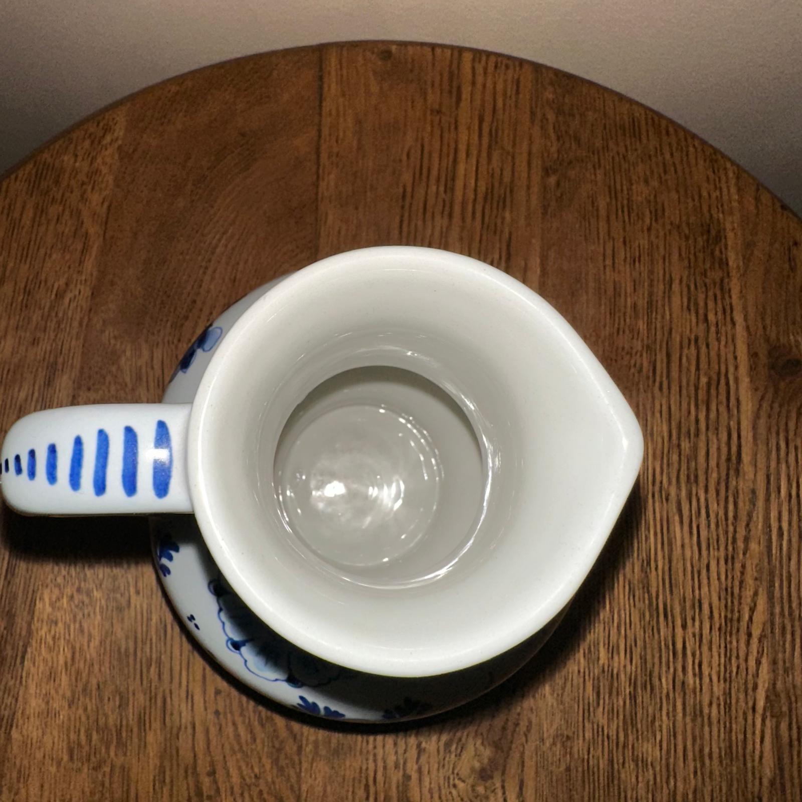 White mug with blue patterns on a wooden surface