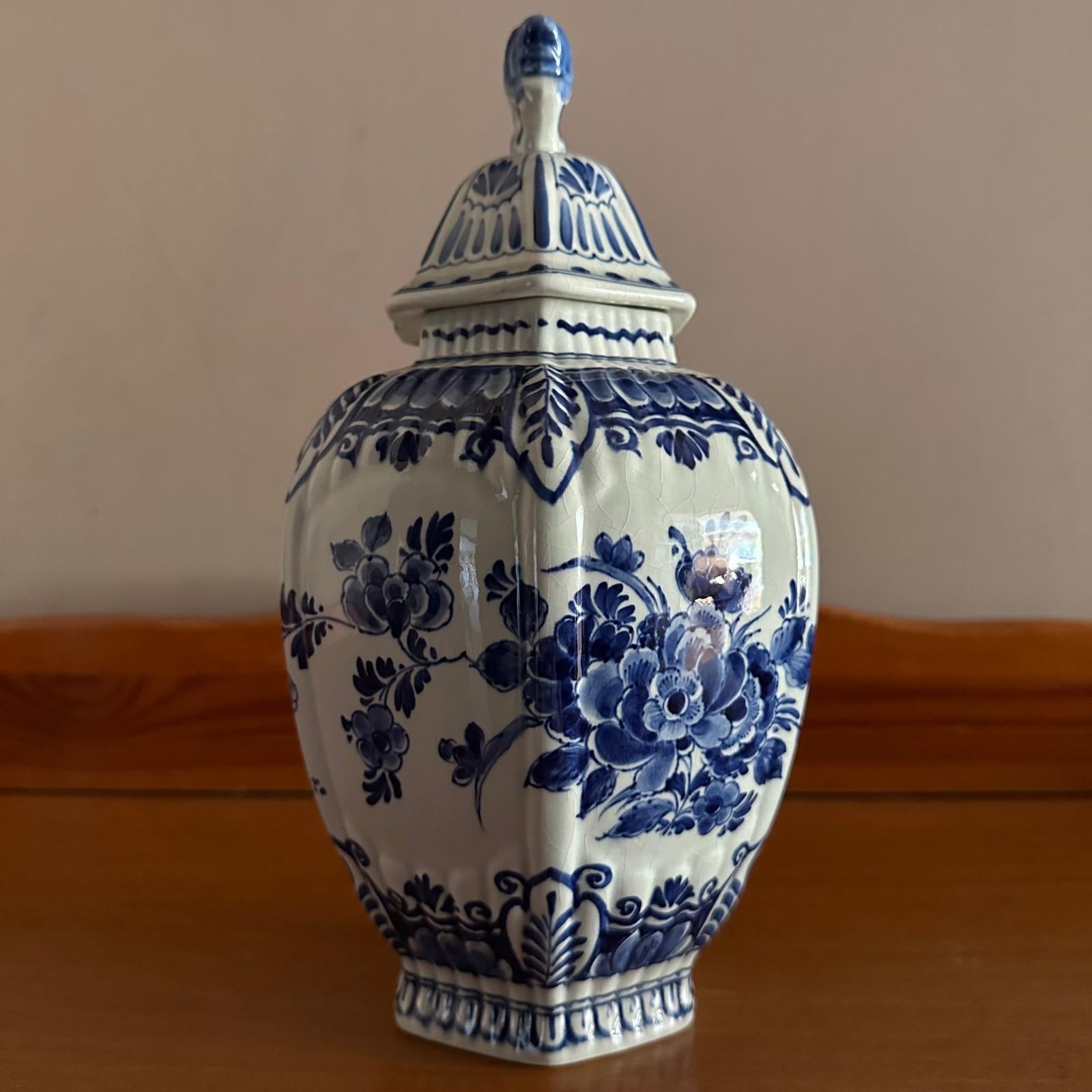 Ceramic jar with blue floral patterns on a wooden surface